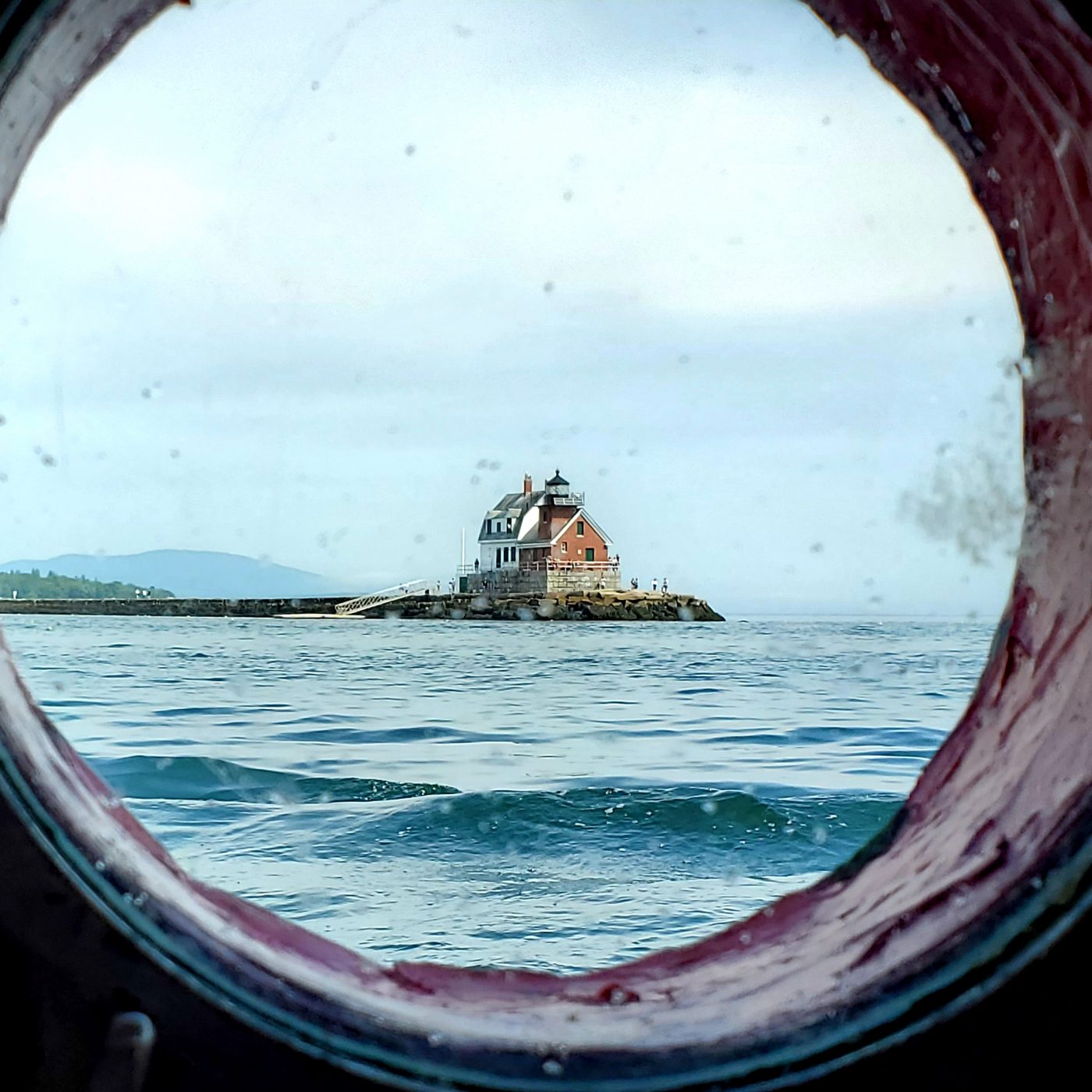 Porthole with lighthouse